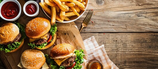 Canvas Print - Two fresh homemade burgers with fried potatoes on a wooden table With copy space. Creative Banner. Copyspace image