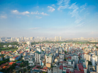 Wall Mural - Dense of multistory residential houses with caged balcony and row of high-rise apartment tower complex in background at Van Quan, Ha Dong District, Southwest of Hanoi, Vietnam