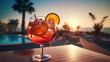 Closeup of fresh delicious summer drink or cocktail with decoration of oranges in sunset ocean background atmosphere
