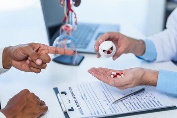 Wall Mural - Doctor hands holding sectional model of prostate gland while male patient observes, suggesting discussion about prostate cancer, cystitis, urinary tract infection, potential medicines for treatment.