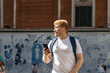© PEDROMERINO - Young albino man using smartphone in the city