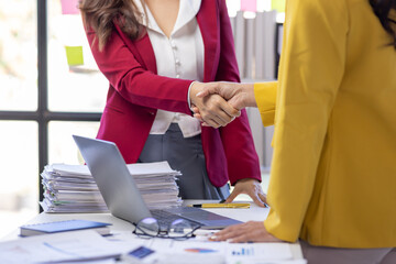 Wall Mural - Business partnership concept. Asian women or employees Cropped image of two businesswomen handshake.