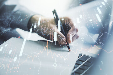 Poster - Multi exposure of abstract financial diagram with world map and with hand writing in notepad on background with laptop, banking and accounting concept