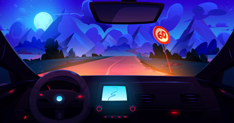 Wall Mural - View from car through windshield on road with sign going across meadow to high rocky mountains at night under moon light. Dark dusk landscape with hills through automobile window with navigation panel