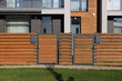 Wooden fence near modern residential cottages