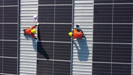 Wall Mural - Engineering technician is professional trained in skills and techniques installing solar photovoltaic panels system on power industrial factory roof, Engineering concepts to good environment.	