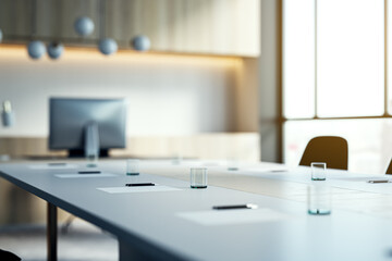 Wall Mural - Close up of white table with items in modern conference room. Blurry interior background. Workplace concept. 3D Rendering.