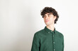 © Westend61 - Smiling man with curly hair wearing green shirt against white background