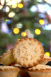 A pile of traditional british mince pies with a typical Christmas style background.