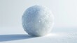 A snow ball sitting on top of a snow covered ground. Perfect for winter-themed designs and holiday projects