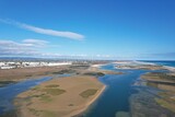 Fototapeta Na ścianę - aerial drone view of climate in praia da fuseta in algarve portugal with fields, lakes and beach next to the atlantic ocean and nature