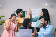 © WESTOCK - Group of team members celebrating success after seeing received mail from the laptop at office - concept of project deal, new business or client agreement and startup collaboration