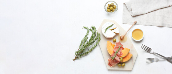 Wall Mural - Tasty melon with prosciutto, cheese, olives and honey on white background with space for text