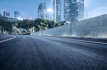 Wall Mural - Empty asphalt road and city buildings landscape at night in Guangzhou