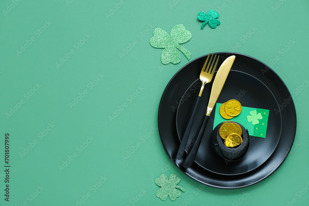 Beautiful table setting for St. Patrick's Day celebration on green background