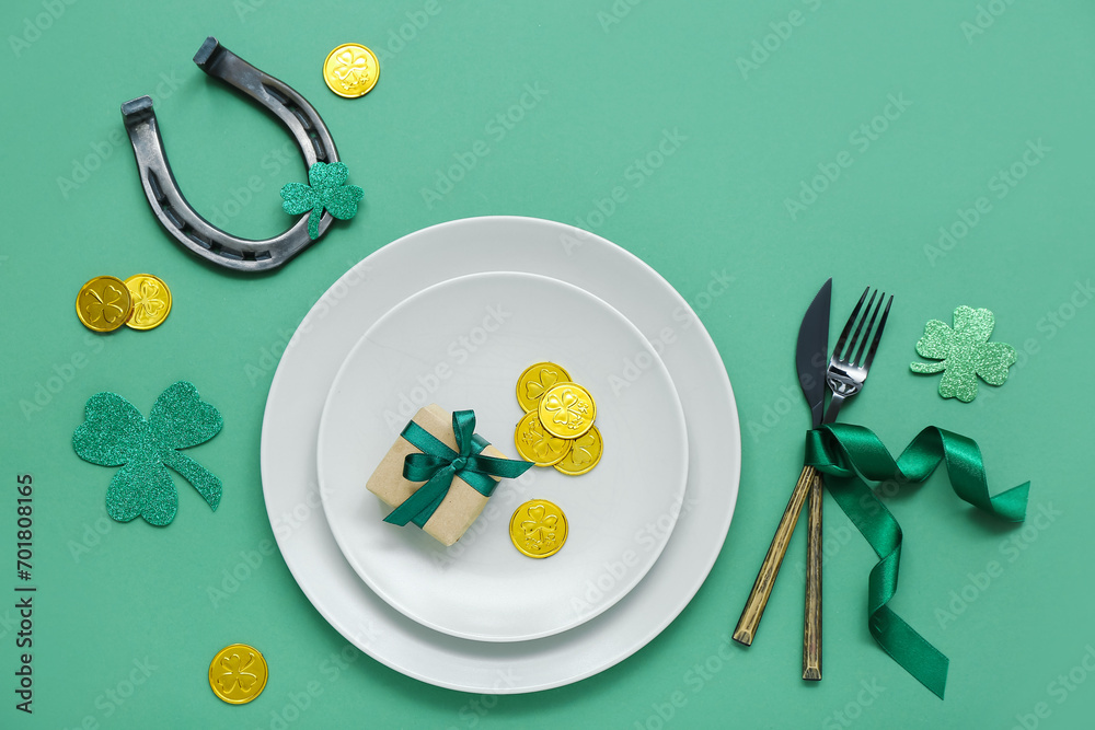 Beautiful table setting for St. Patrick's Day celebration on green background