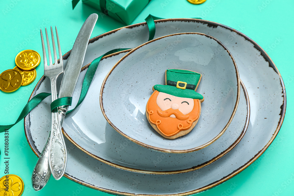 Beautiful table setting for St. Patrick's Day celebration on turquoise background