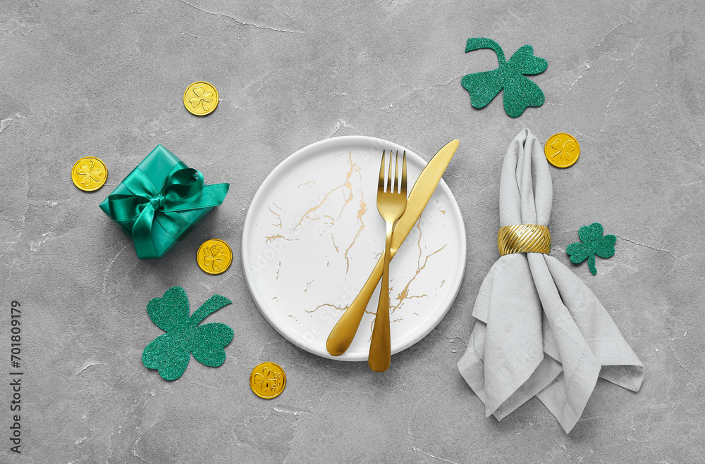 Beautiful table setting for St. Patrick's Day celebration on grey background