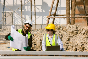 Wall Mural - Engineers and Architect Caucasian looking at blueprint of building construction, planning the work in a professional. inspector is looking at steel structure and materials at construction site.