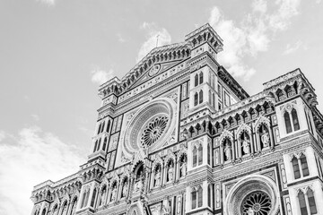 Decorations of the top facade of the Florence Cathedral, cathedral of Santa Maria del Fiore in Florence, Tuscany, Italy in black and white