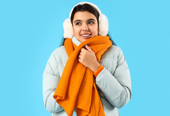 Sticker - Young woman in winter clothes on blue background