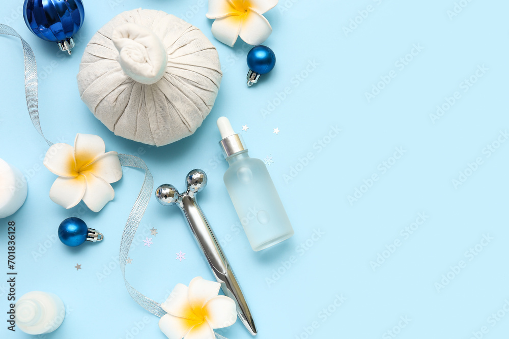 Composition with spa accessories, Christmas decorations and tropical flowers on color background