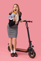 Poster - Portrait of young businesswoman with megaphone and kick scooter on pink background