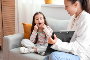 Sticker - Little girl with speech therapist pronouncing letters in office