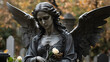 Sculpture of an angel with wings at a funeral in a cemetery near a gravestone. The angel of death and life meets the soul of the deceased