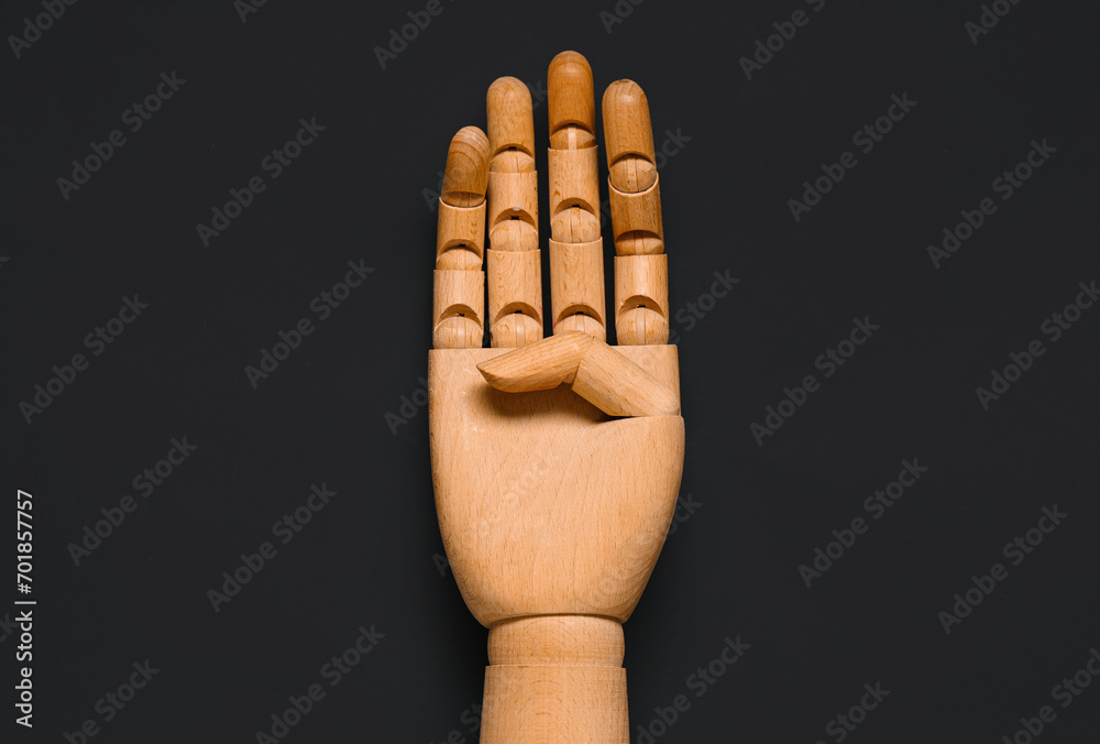 Wooden hand on dark background, closeup. Domestic violence concept