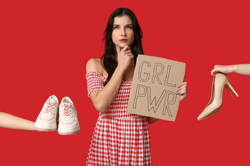 Wall Mural - Thoughtful young woman with sign GRL PWR and shoes on red background. Feminism concept