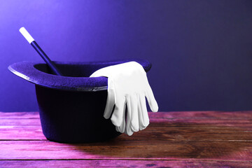 Wall Mural - Top hat, gloves and wand on wooden table, space for text. Magician equipment