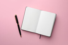 Open Notebook With Blank Pages And Pen On Light Pink Background, Top View. Space For Text