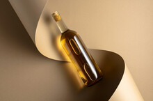 Bottle of white wine on a beige background.