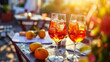 Two glasses of Aperol Spritz cocktail on restaurant table served outside