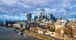 London panorama from iconic Tower Bridge in western direction on a sunny winters day. Modern skyline of tall buildings in town center and banks of river Thames with Tower castle, pier and vessels. 