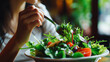 A close-up of a woman enjoying a healthy food salad, symbolizing attention to nutrition and body well-being