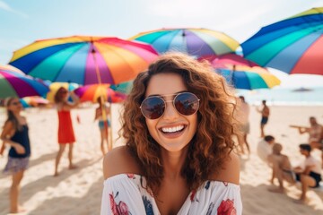 happy woman on the beach in summer against the background of the sea or ocean and colorful umbrella