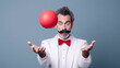 A juggler with a mustache and a white jacket juggles a red ball