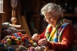 © Anna - Elderly woman's hands knitting something from balls of yarn