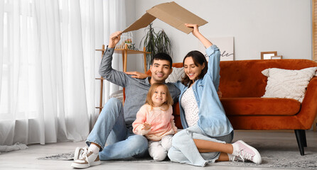 Wall Mural - Happy family with cardboard dreaming about their new house at home