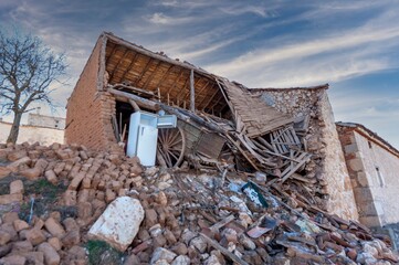 An abandoned house collapses. The house is destroyed.