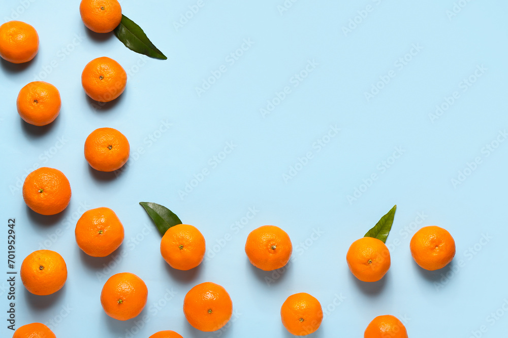 Many sweet mandarins on light blue background