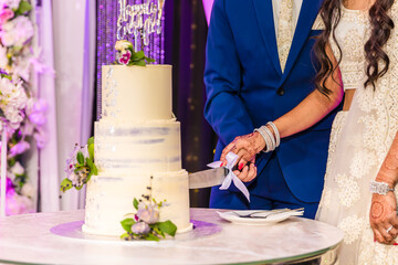 Sticker - Indian couple's cutting a wedding cake hands close up