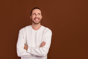 Wall Mural - Photo of dreamy funky man wear white sweater arms crossed looking empty space isolated brown color background
