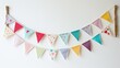 A charming fabric banner, lovingly stitched with colorful bunting and adorned with playful pompoms, adding a touch of childlike wonder and joy to any room.