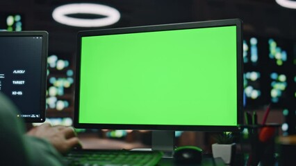 IT specialist working greenscreen pc at datacenter closeup. Man typing computer