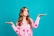 Portrait of young woman wear pink jumper strawberry print hold arms different weight products advantage isolated on blue color background