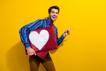 Poster - Portrait of nice guy dressed stylish shirt bow tie hold heart box directing at post empty space isolated on yellow color background