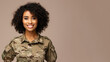 African woman in army uniform smiling isolated on pastel background